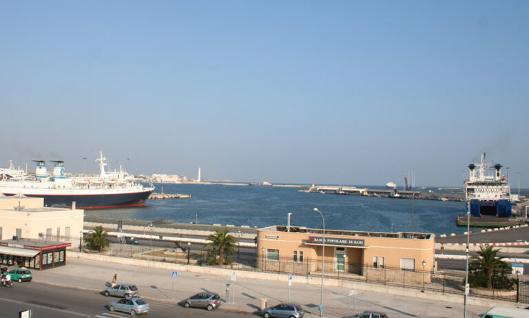 Adriatic seaport, showing the port with docked ships and parked cars on the road