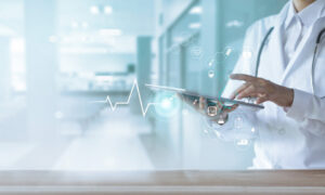 Hospital doctor holding a digital patient record