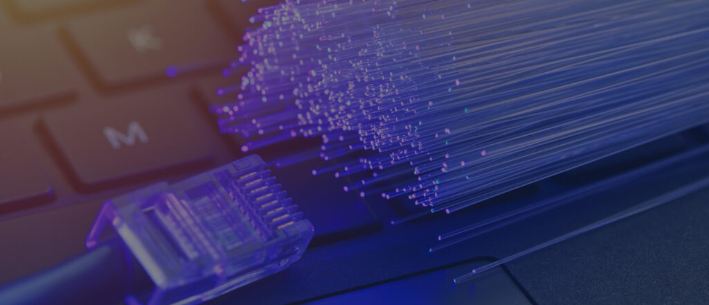 close up view of fibers alongside a cable connector on a keyboard