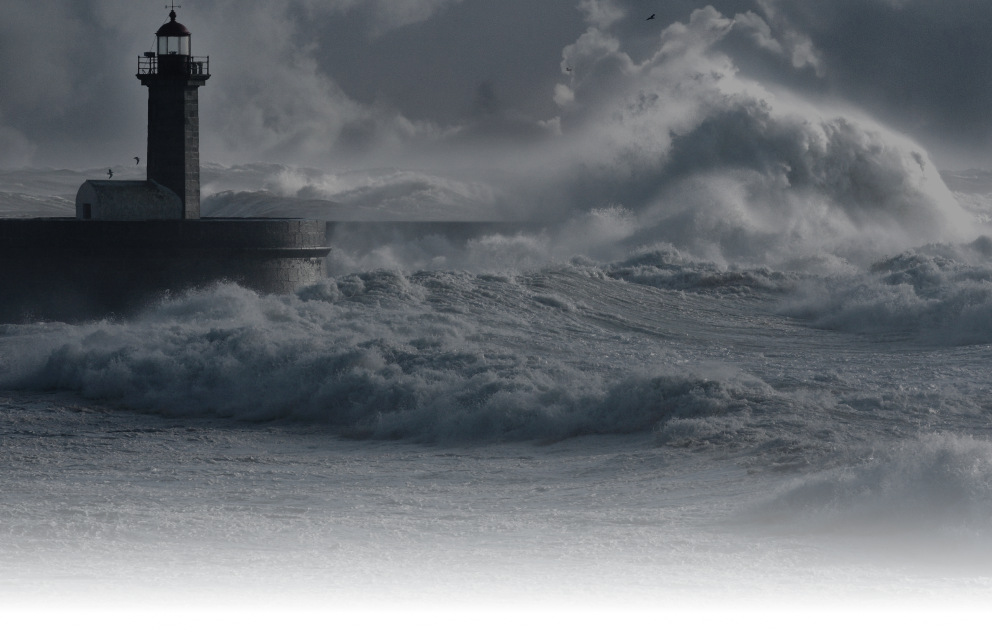 Stormy waves crashing against a lighthouse