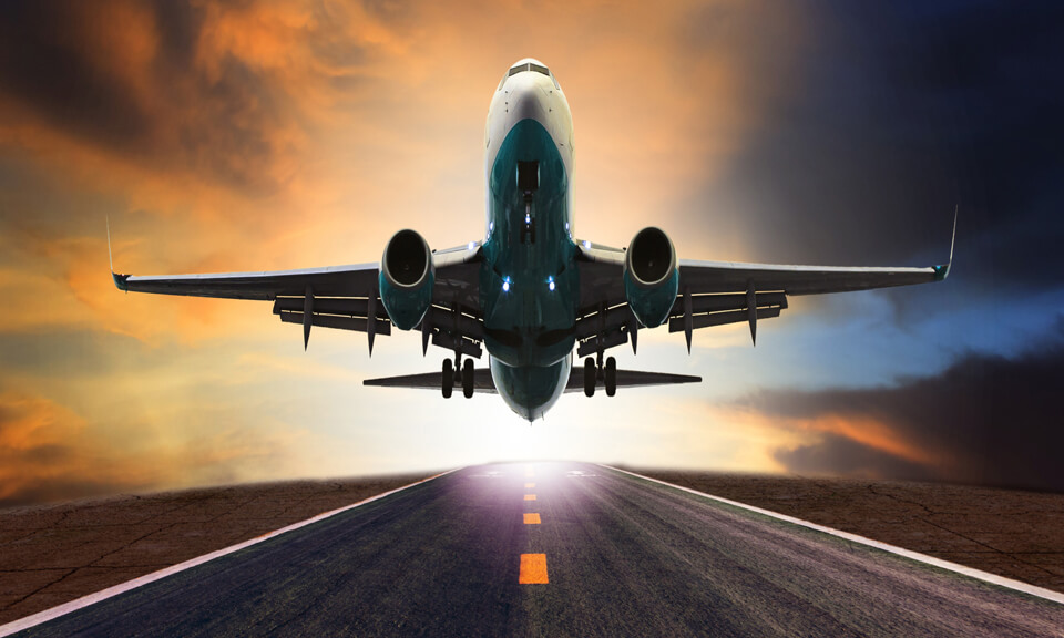 Plane taking off from a runway at night