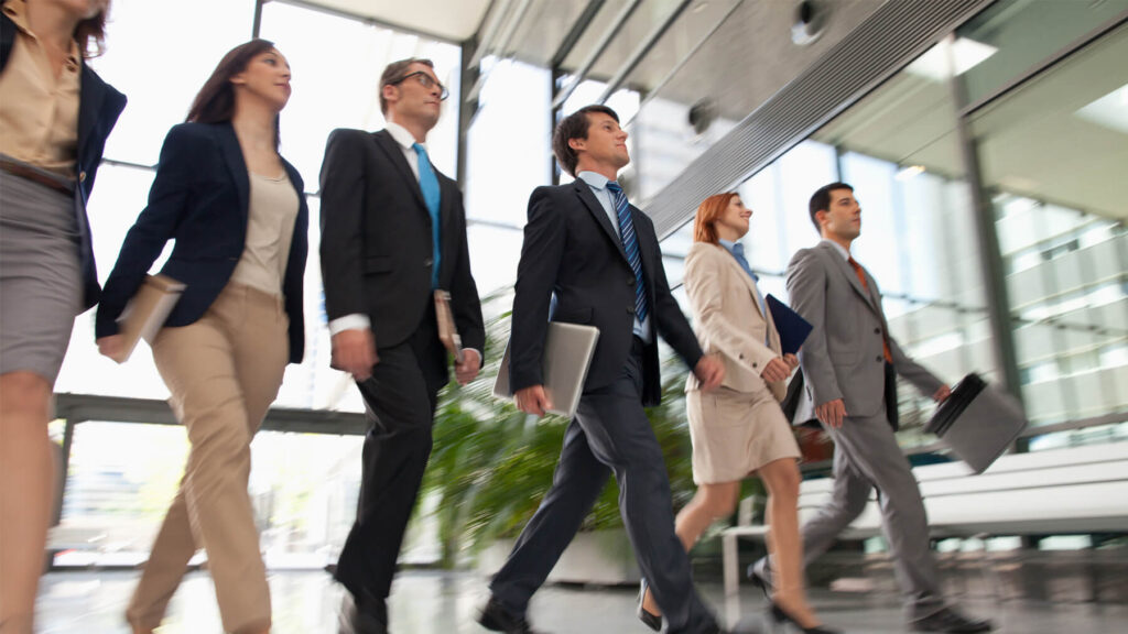 Business people walking in a line in a foyer
