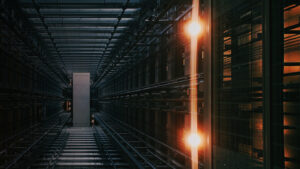 server room racks perspective hallway warm orange glow dark background