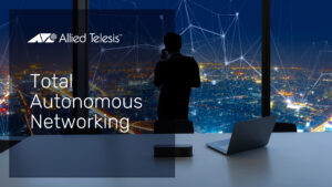 Businessman in office at night watching glowing city network activity