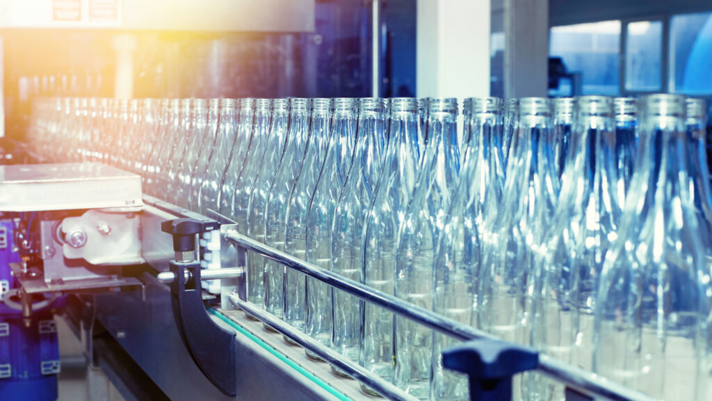 glass bottles on an assembly line