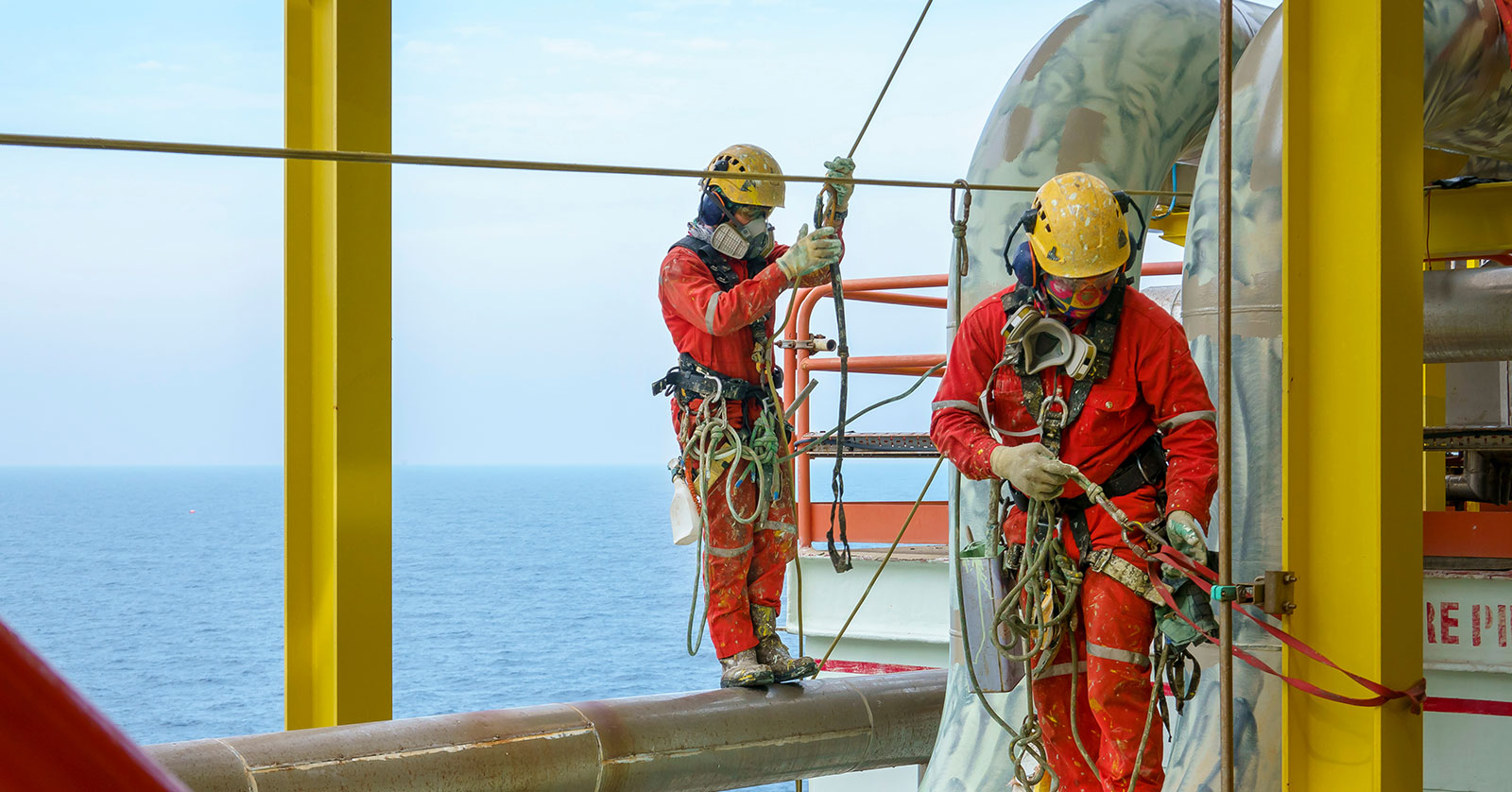 Oil field workers offshore on a rig