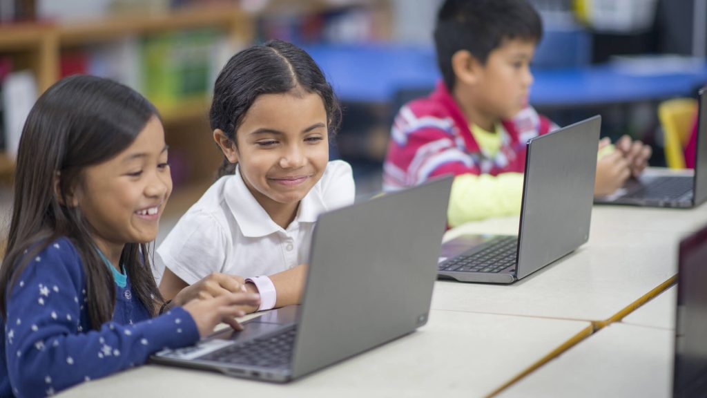 primary school children on laptops