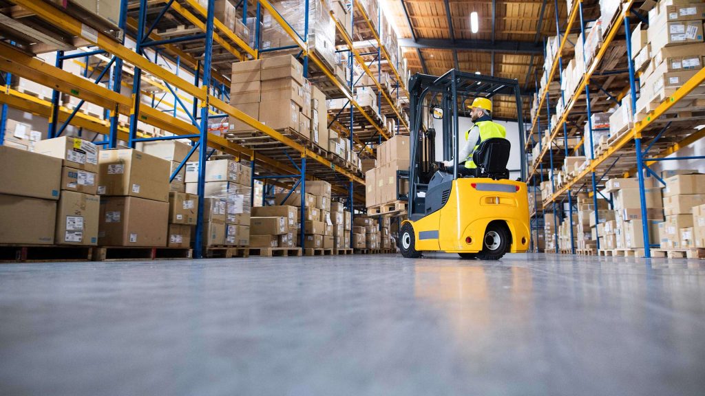 Warehouse fork-lift driver in a warehouse